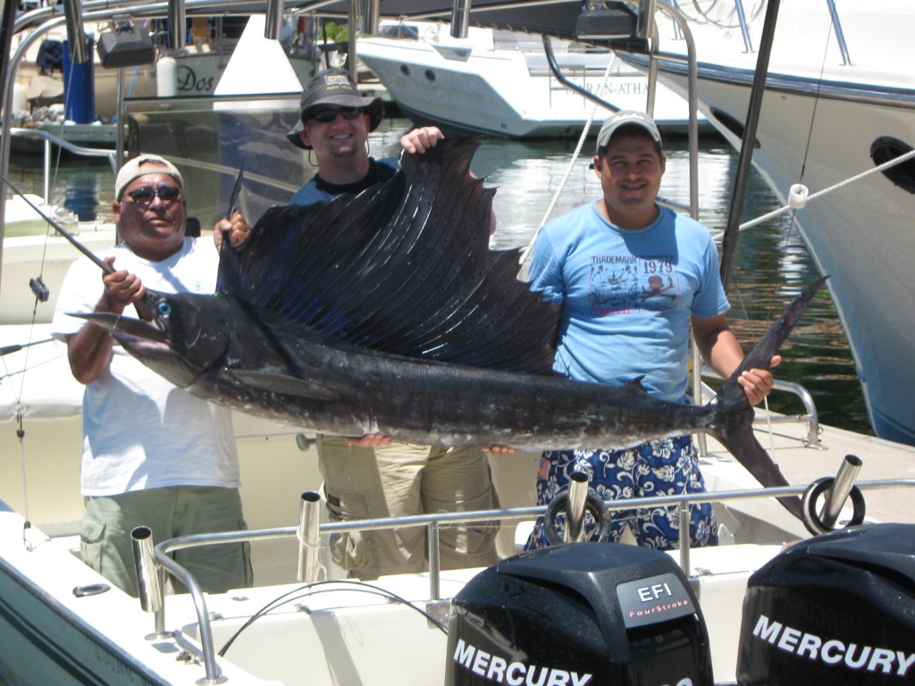 Another Nice Sailfish with Capt. Chema in blue and David Leonard